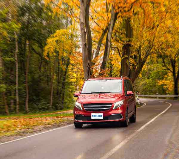 Red van on autumn forest road in Ontario