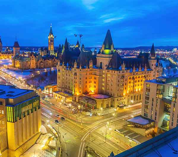 Downtown Ottawa intersection and city skyline with parliament buildings