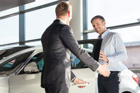 car sales man with a male buyer