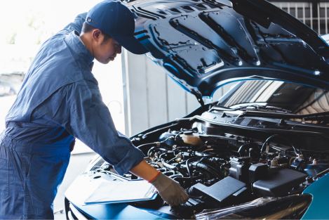 mechanic inspecting a blue car