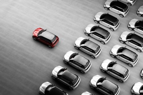 red and grey cars in a parking lot